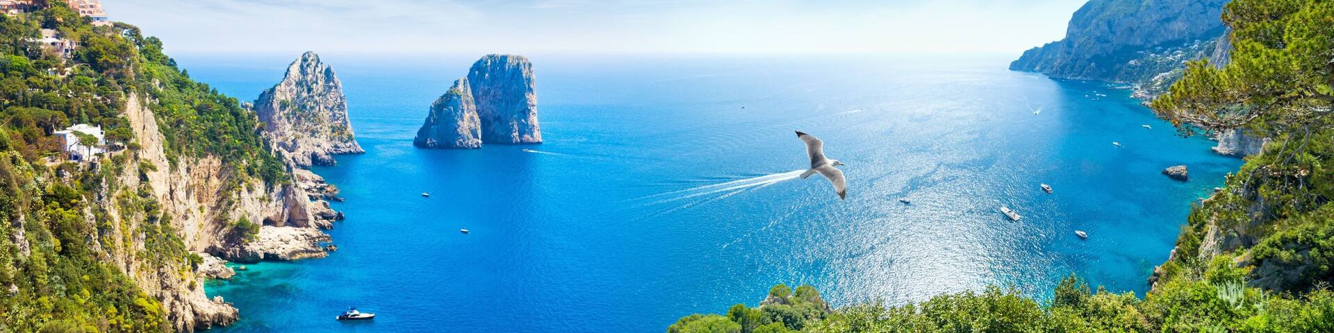 Panoramic collage with famous Faraglioni Rocks, Marina Piccola and Monte Solaro on Capri Island, Italy.