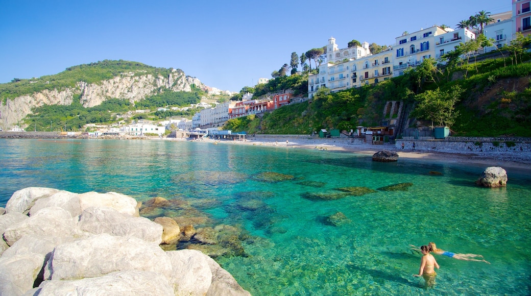 Capri which includes rocky coastline, a coastal town and swimming