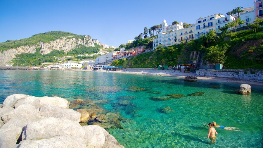 Capri showing a coastal town, rugged coastline and swimming