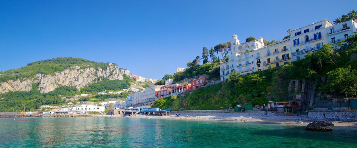 Capri Island featuring a sandy beach and a coastal town