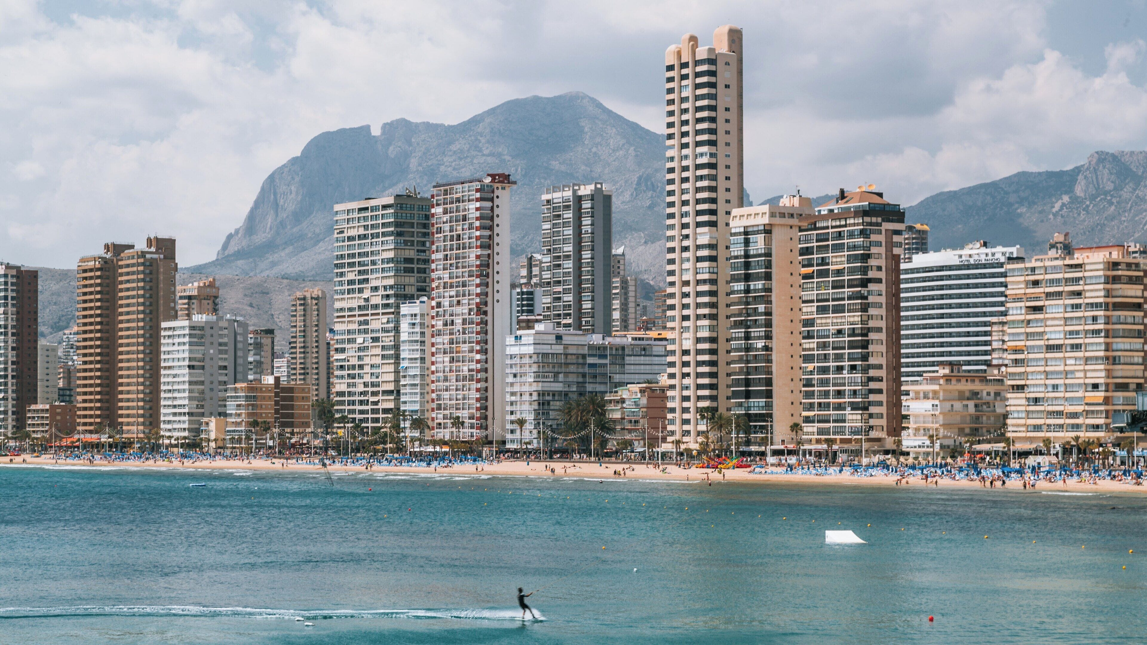 Enjoying water sports at Llevant Beach in Benidorm with stunning views of the skyline and mountains on a sunny day
