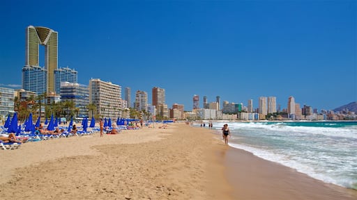 Poniente Beach which includes a coastal town, a beach and general coastal views