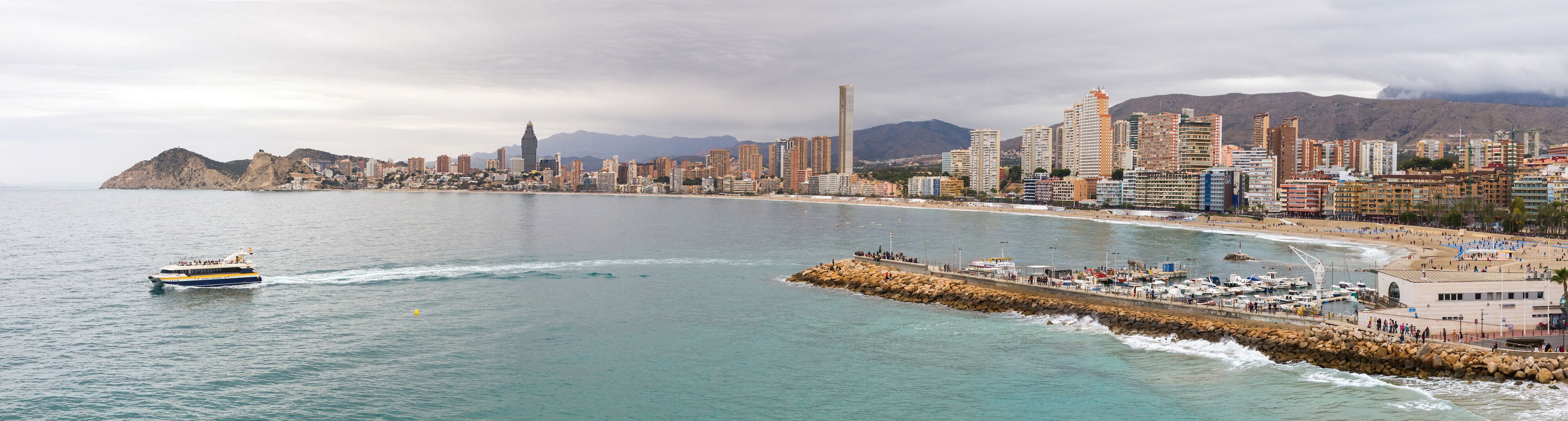 Panoramic view of the Poniente beach in Benidorm with its skyscrapers facing the sea from the Balcon del Mediterraneo and tourist boat  