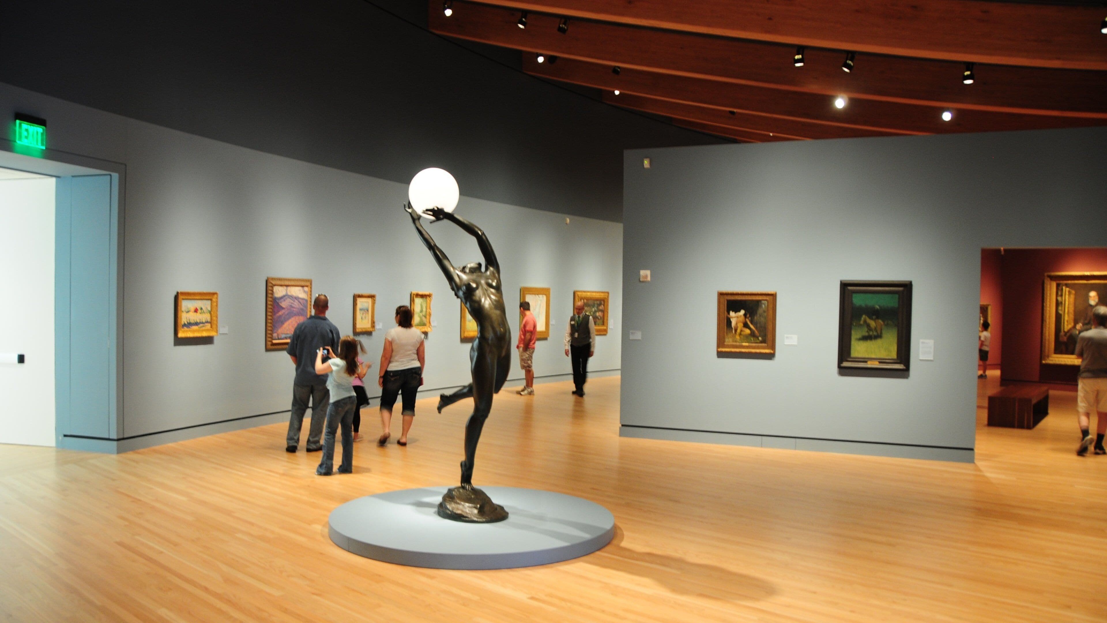 Crystal Bridges Museum of American Art featuring interior views and art as well as a small group of people