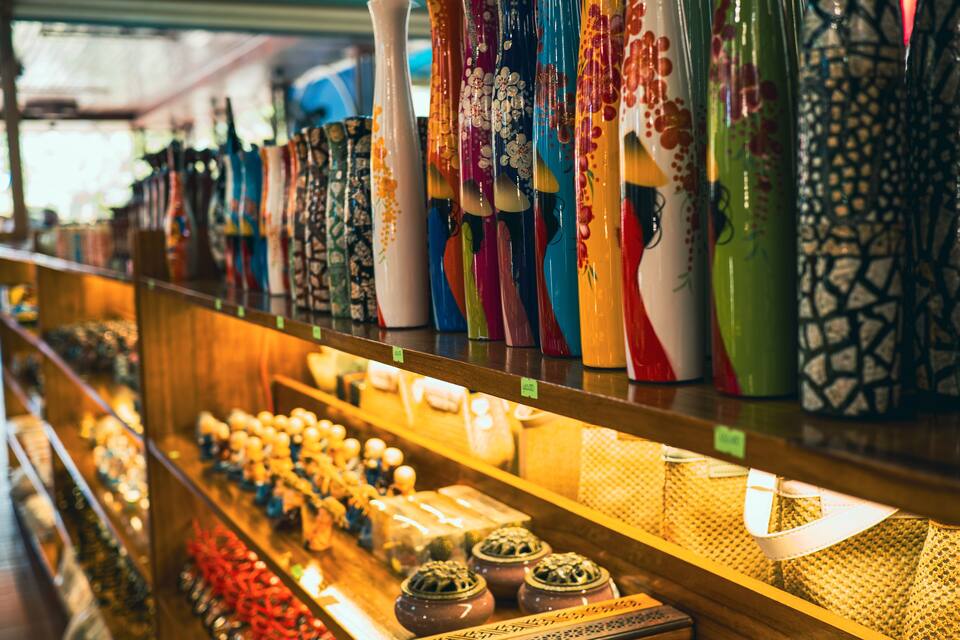 A variety of colorful ceramic vases on display in a shop.