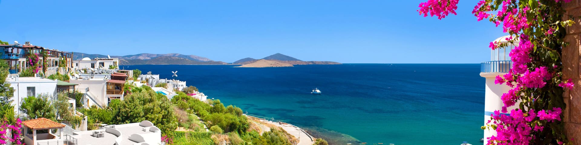 Beautiful flowers frame a sea view of Ortakent, Bodrum, Turkey