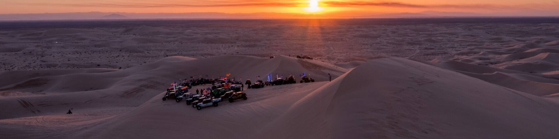 Sunset Over Desert Sand Dunes with Vehicles at Algodones