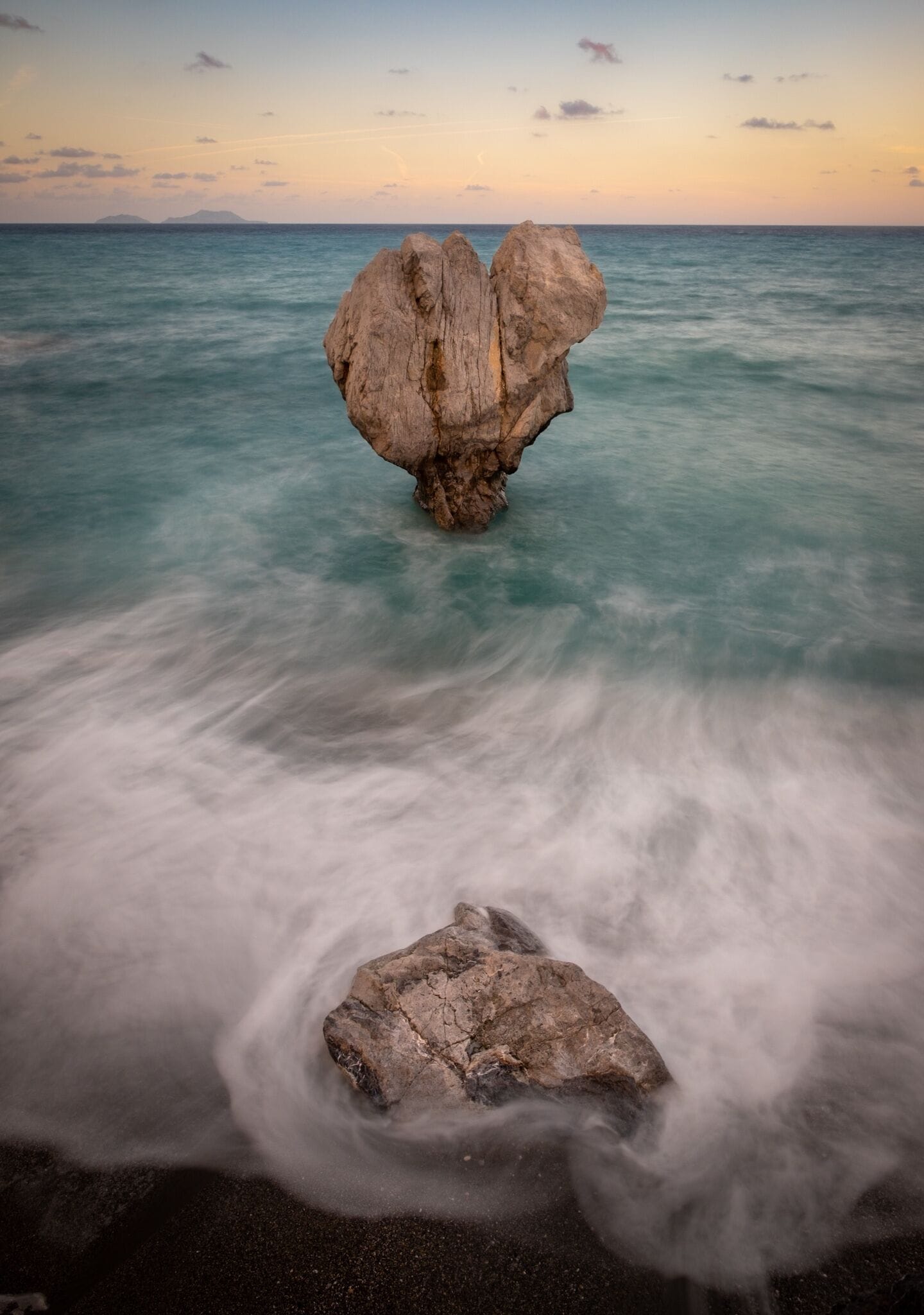 The access to Preveli Beach is best from the west (near Preveli Monastery), where you can hike down to the beach. The obvious shot I guess, is this rock in the shape of a heart. 
There are a lot of possibilities for composition, the high tides in these day forced me to shoot straight from an upper position.

(21mm / f8 / 2.6sec)