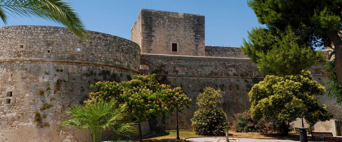 A historic stone castle with a round tower and a rectangular building.