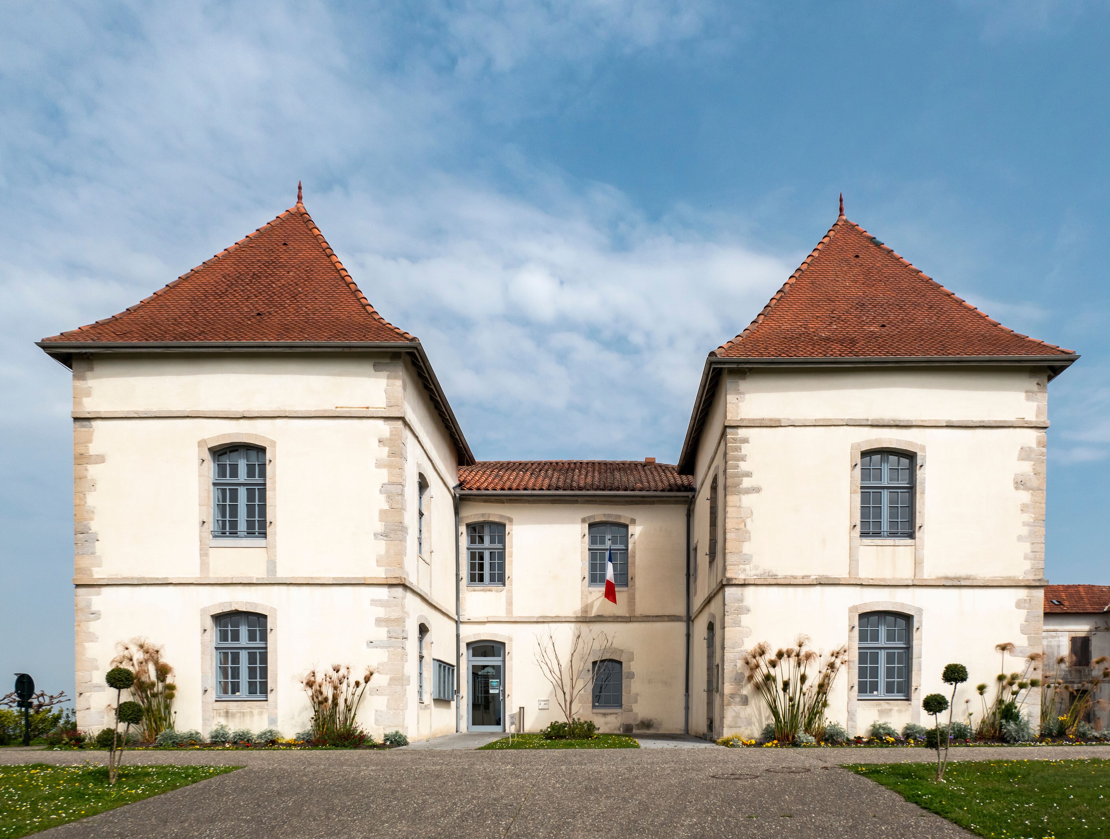 A historic building with two symmetrical towers and a central entrance.
