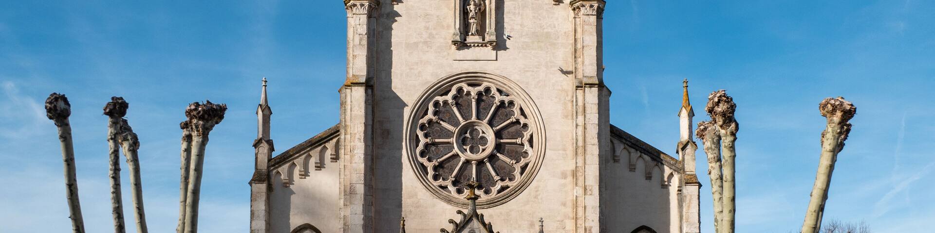 A Gothic-style church with a large circular window and pointed arches.