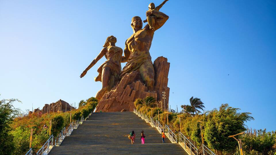 A large statue of a man and woman on a staircase.