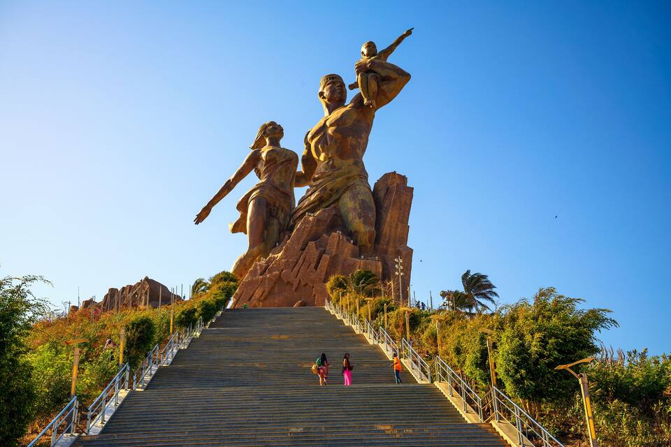 A large statue of a man and woman on a staircase.