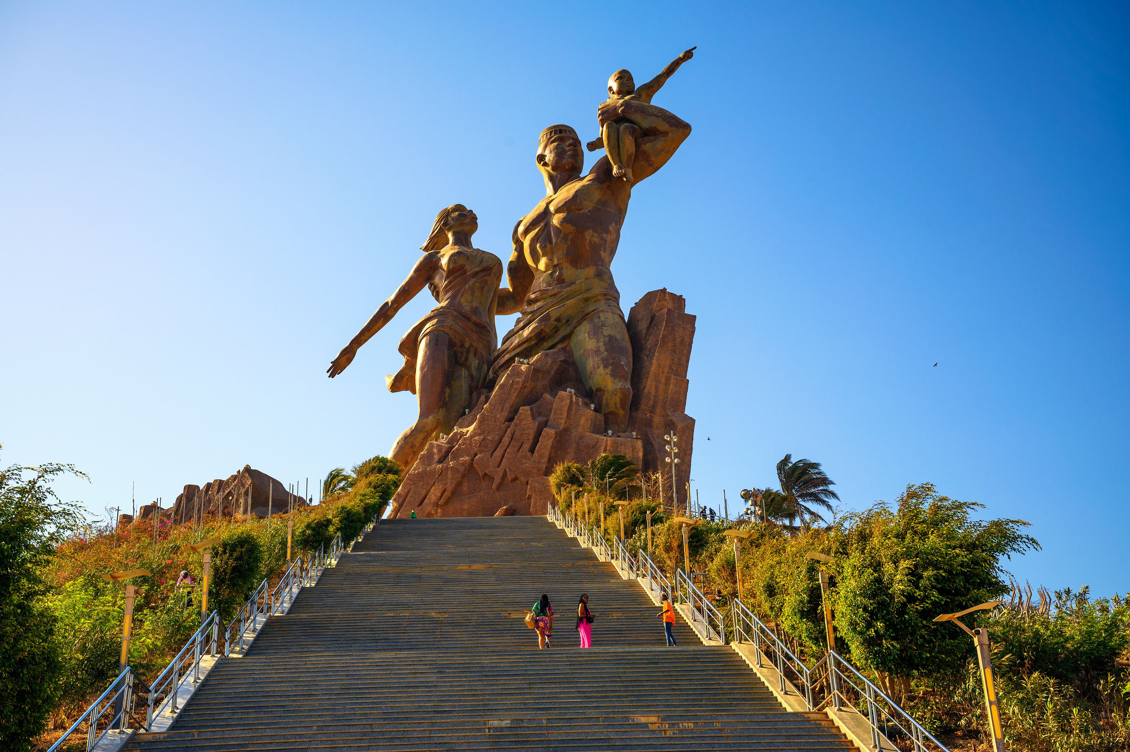 A large statue of a man and woman on a staircase.