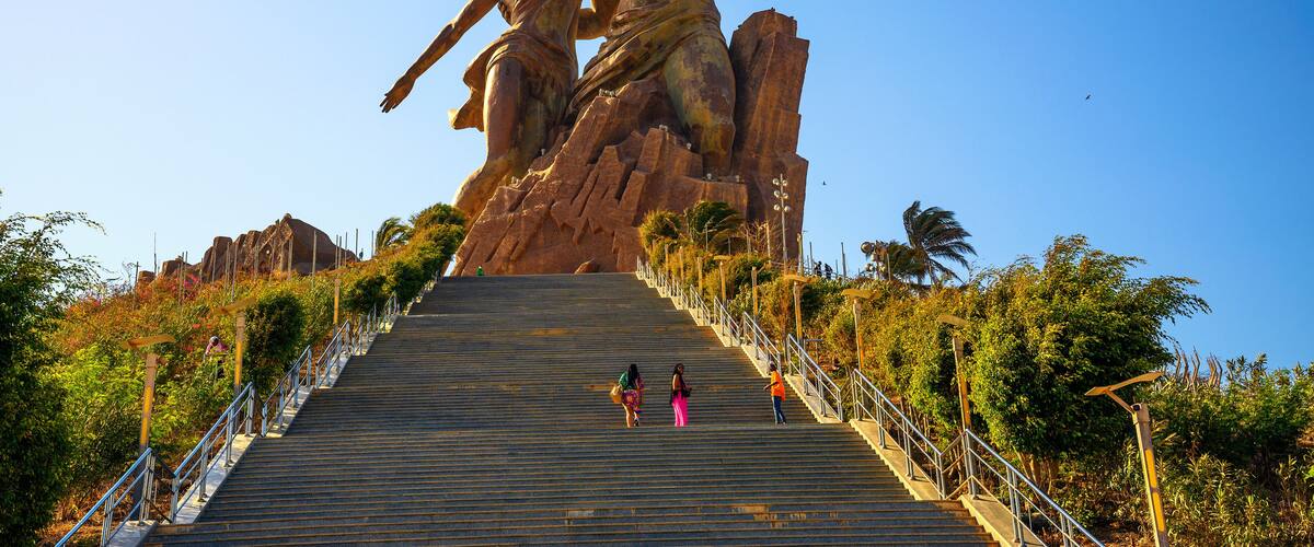 A large statue of a man and woman on a staircase.