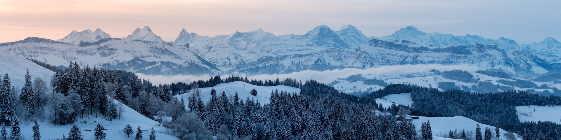 panoramic view on a beautiful winter sunrise in snowy Emmental