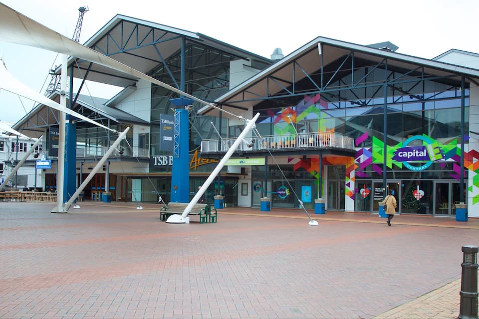 A modern building with a glass facade and colorful geometric patterns.