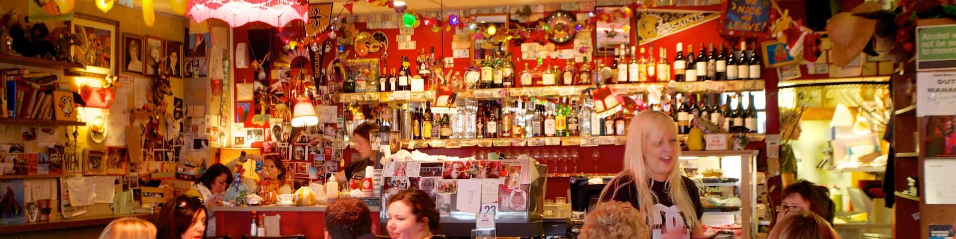 Courtenay Place featuring a bar and interior views as well as a small group of people