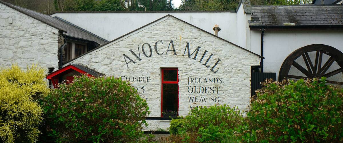 A building with the sign "AVOCAMILL" and "IRELANDS OLDEST WEAVING" on its facade.