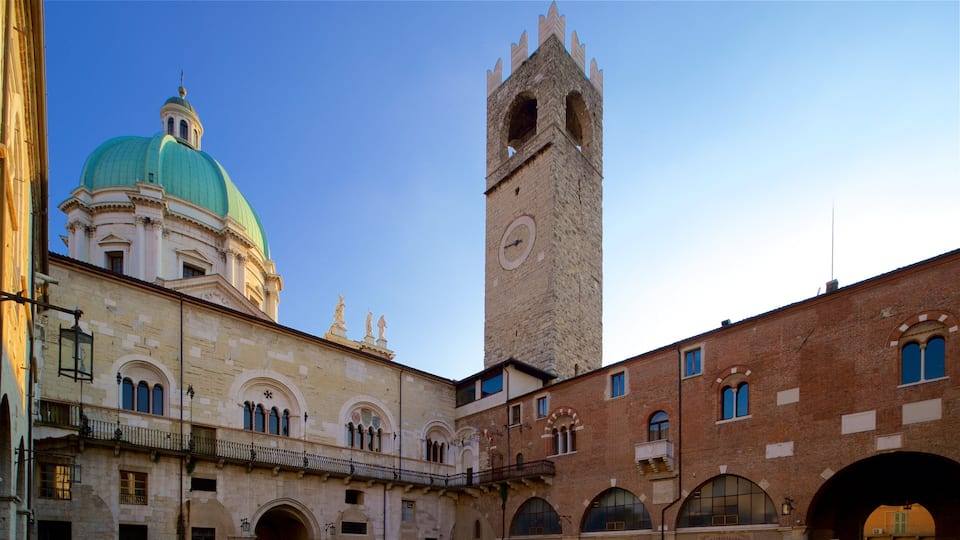 A historic building with a green dome and a tall clock tower.