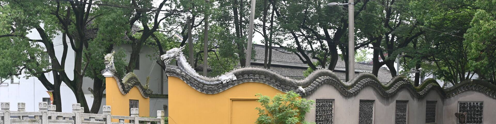 nice contrast of yellow stone wall, gray stone bridge, green canal and vegetation all around