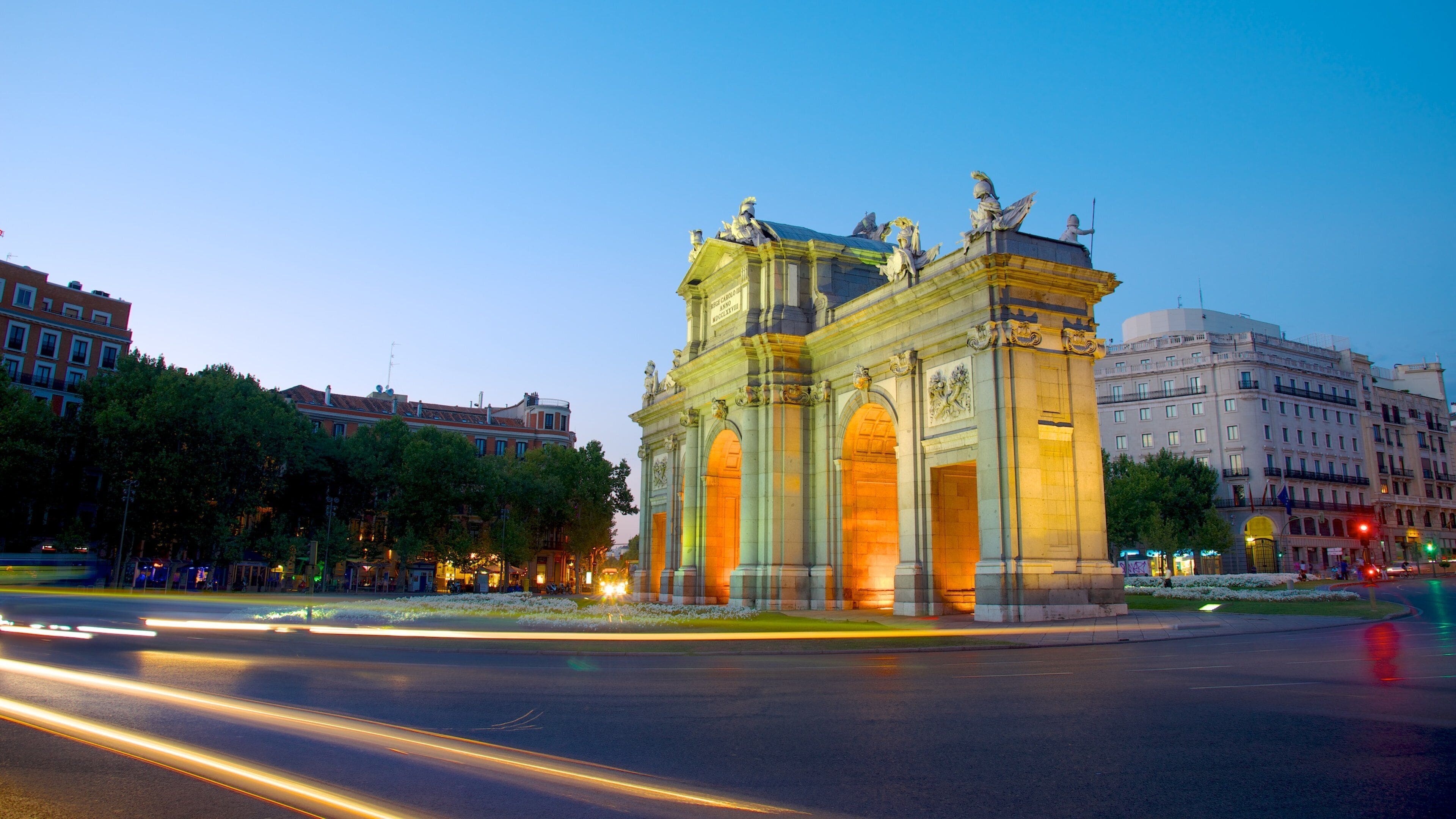 Puerta de Alcalá featuring a city, night scenes and street scenes