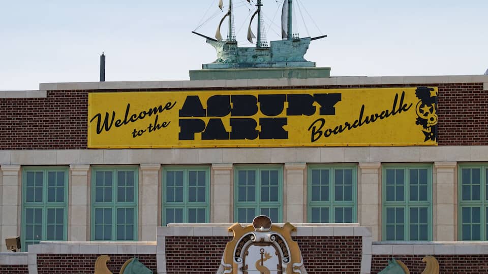 A building with a sign that reads "Welcome to the Asbury Park Boardwalk."