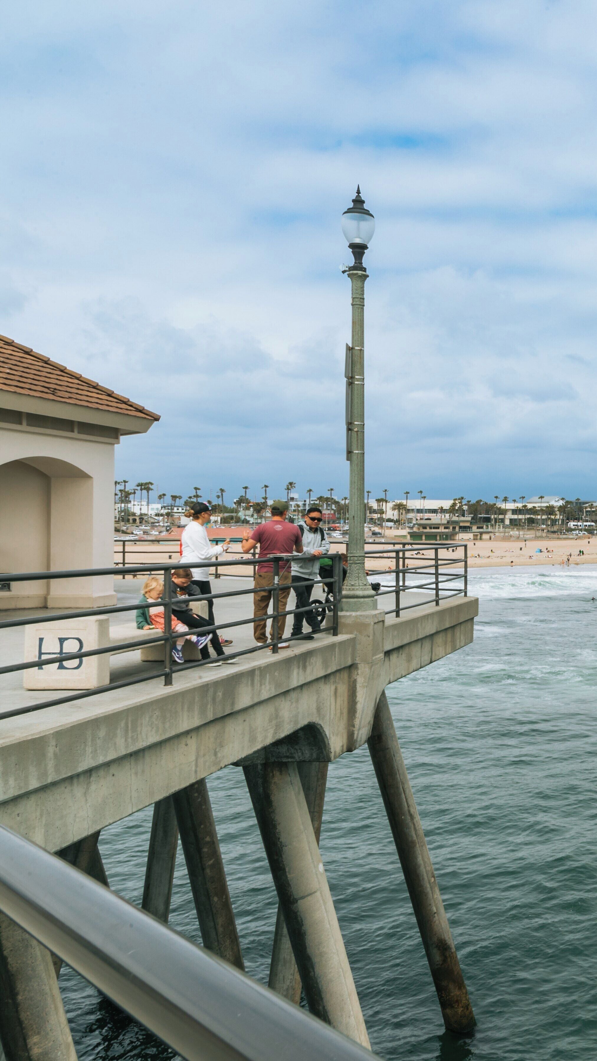 Enjoying time together on Huntington Beach Pier while overlooking the ocean in sunny California