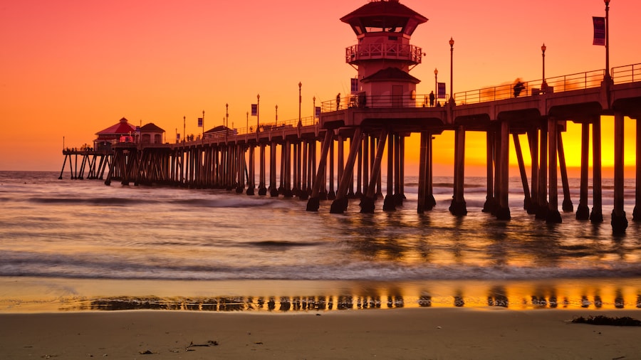 A wide shot of the Huntington Beach Pier during a bright red and orange sunset.; Shutterstock ID 95489323
