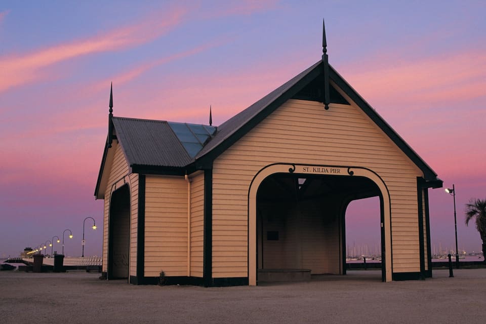 A wooden pier with a pointed roof and a sign reading "St. Kilda Pier".