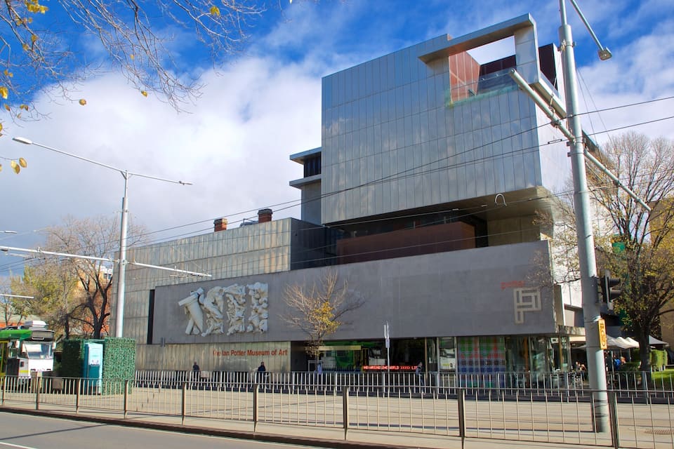 A modern building with a large sculpture of a wizard on its facade.