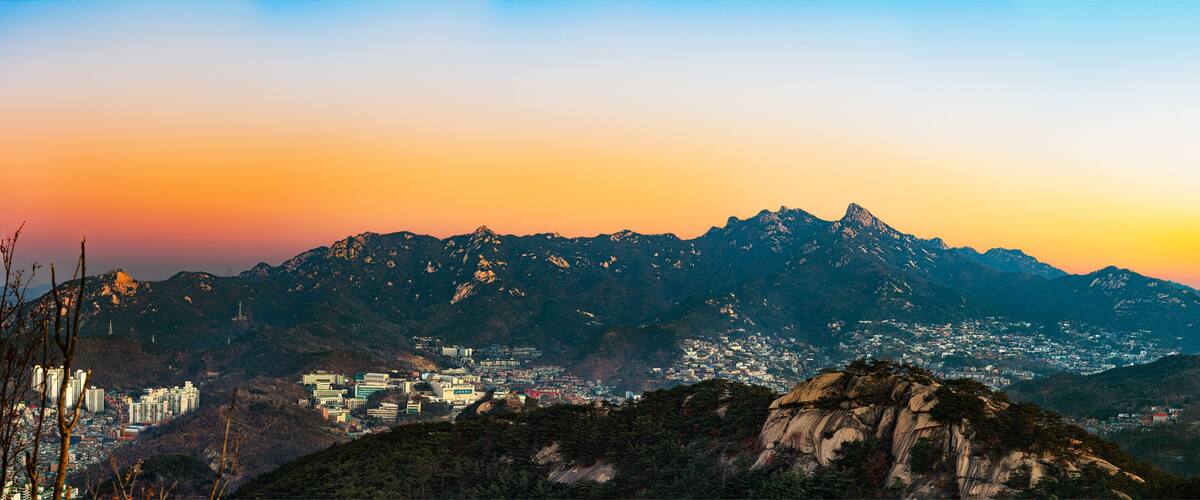 A mountainous landscape with a city in the valley.
