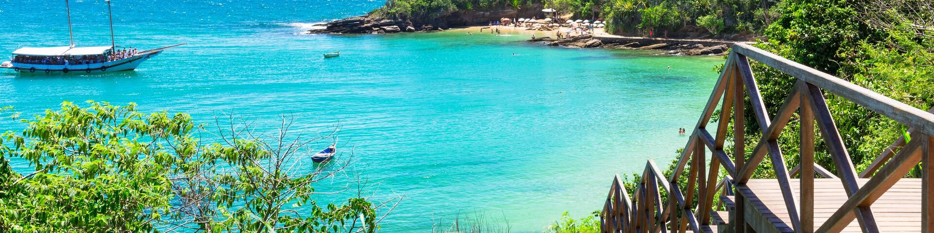 A turquoise sea, a wooden pier, and a boat.