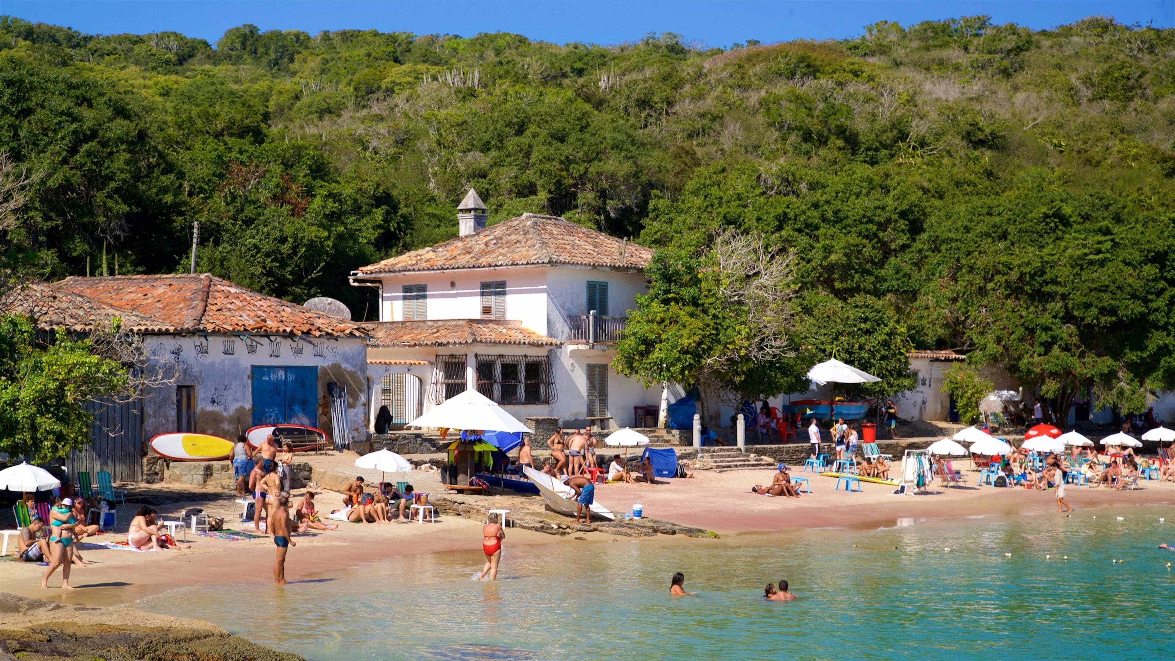 Azeda Beach showing swimming, a beach and a coastal town