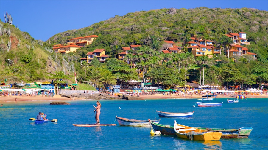 Joao Fernandes Beach showing a coastal town, kayaking or canoeing and general coastal views