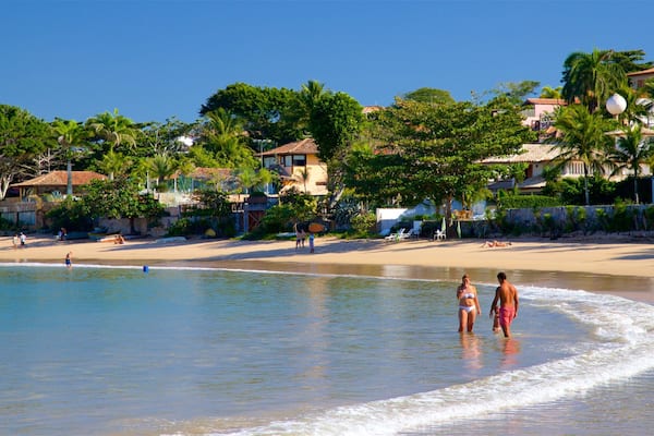 Playa Ferradura que incluye una playa de arena, una localidad costera y natación