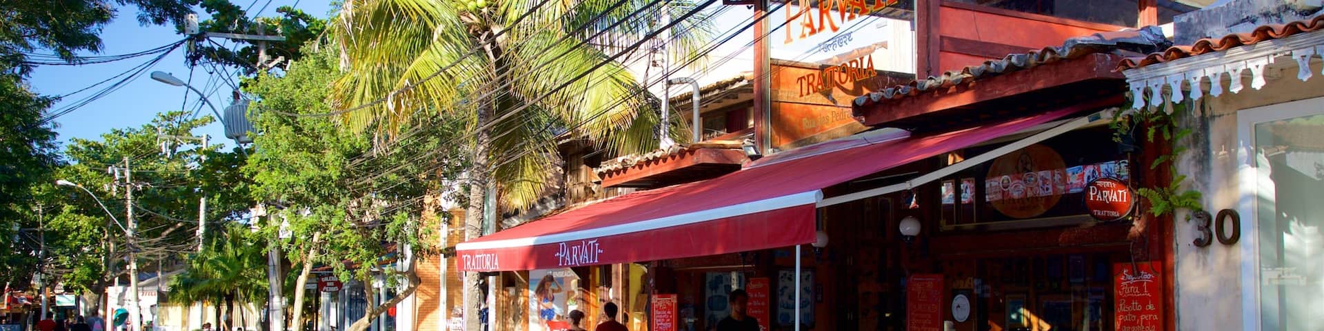 A cobblestone street lined with outdoor seating at a restaurant named Parvati.