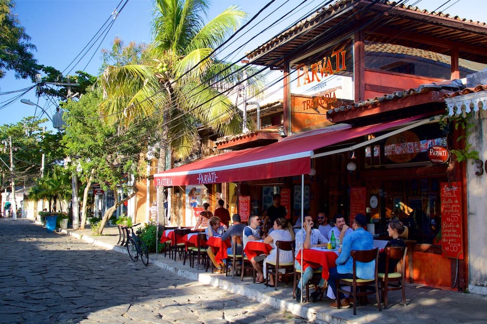 A cobblestone street lined with outdoor seating at a restaurant named Parvati.