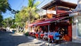 A cobblestone street lined with outdoor seating at a restaurant named Parvati.