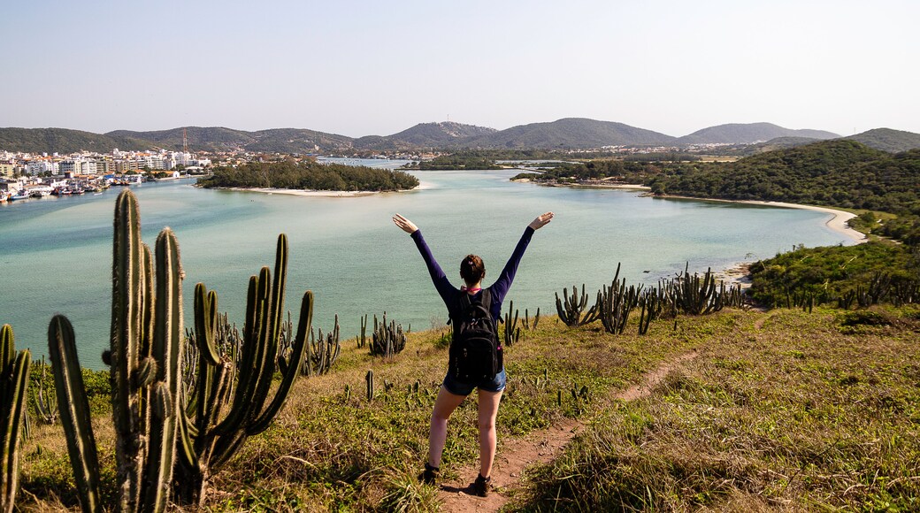 Model glimpsing landscape of Araruama lagoon, Cabo Frio, Rio de Janeiro, Brazil.