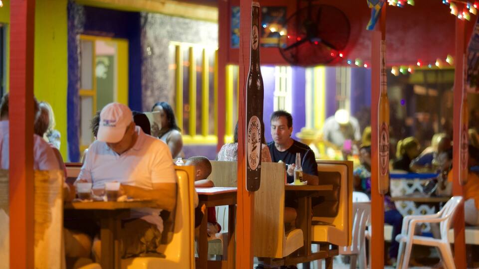 Smith Point showing night scenes, outdoor eating and a beach bar