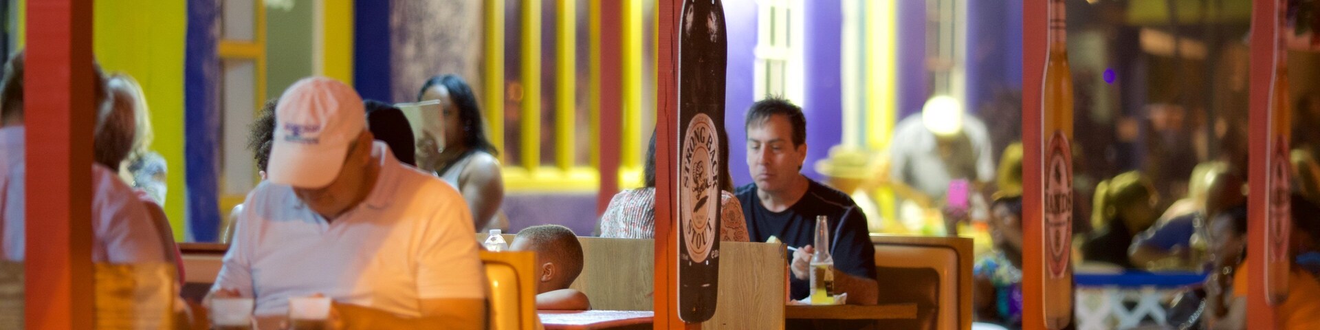 Smith Point showing night scenes, outdoor eating and a beach bar