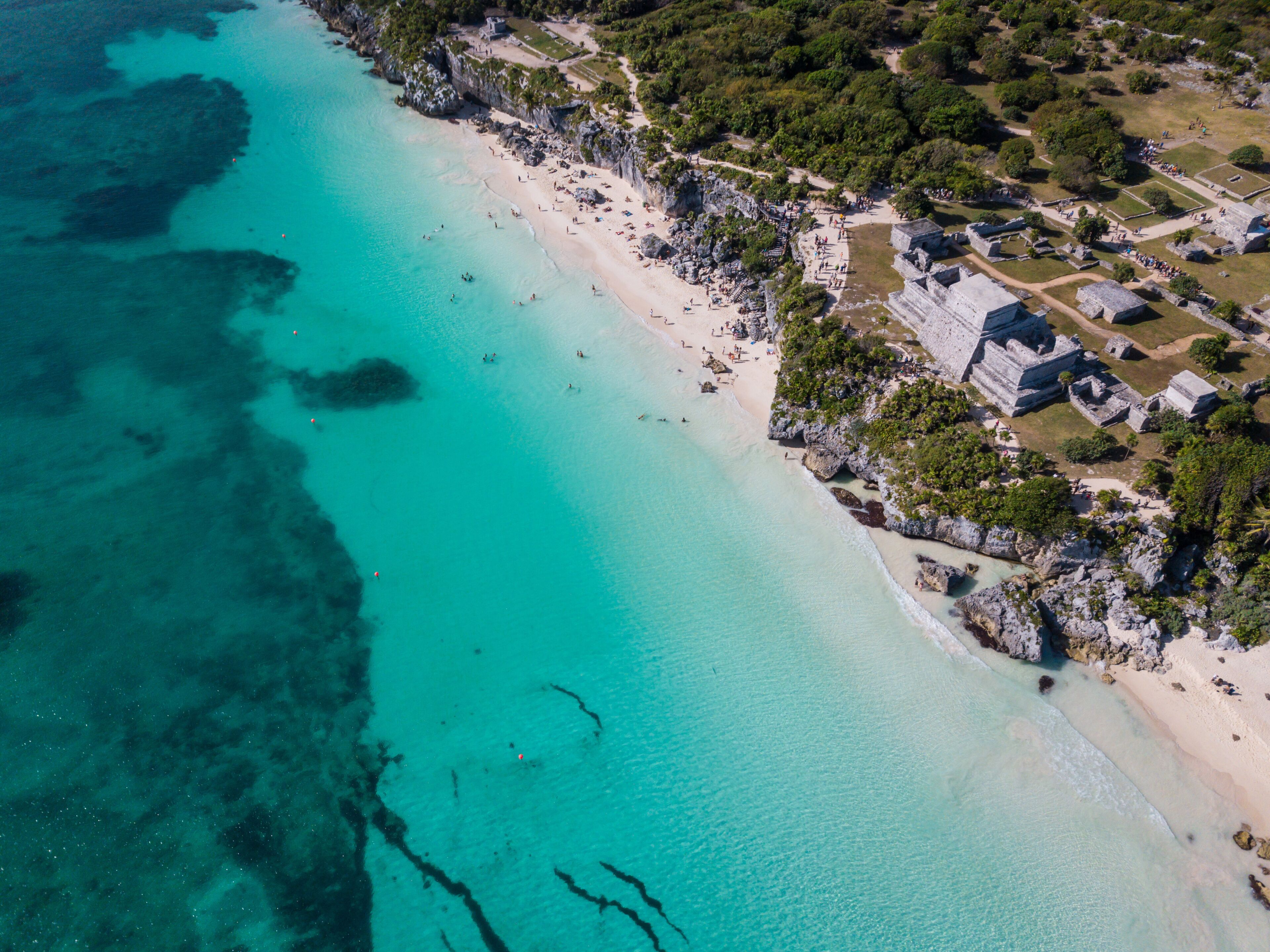 Ruins of Tulum, Mexico overlooking the Caribbean Sea in the Riviera Maya Aerial View. Tulum beach Quintana Roo Mexico - drone shot. White sand beach and ruins of Tulum.