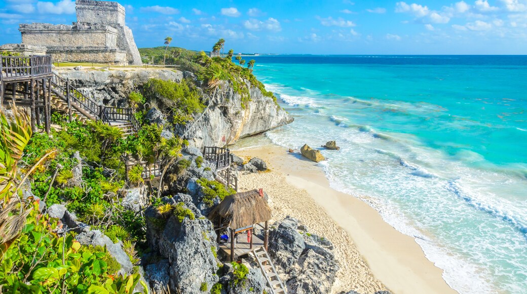 Mayan ruins of Tulum at tropical coast. El Castillo Temple at paradise beach. Mayan ruins of Tulum, Quintana Roo, Mexico.