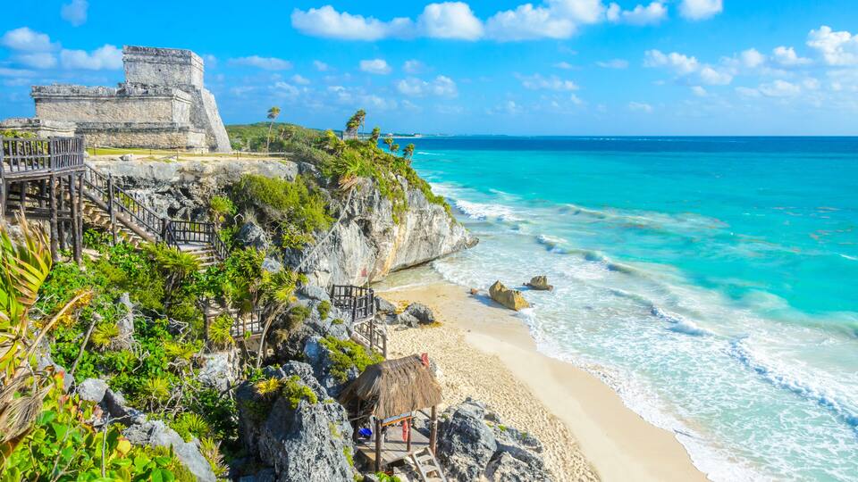 Mayan ruins of Tulum at tropical coast. El Castillo Temple at paradise beach. Mayan ruins of Tulum, Quintana Roo, Mexico.