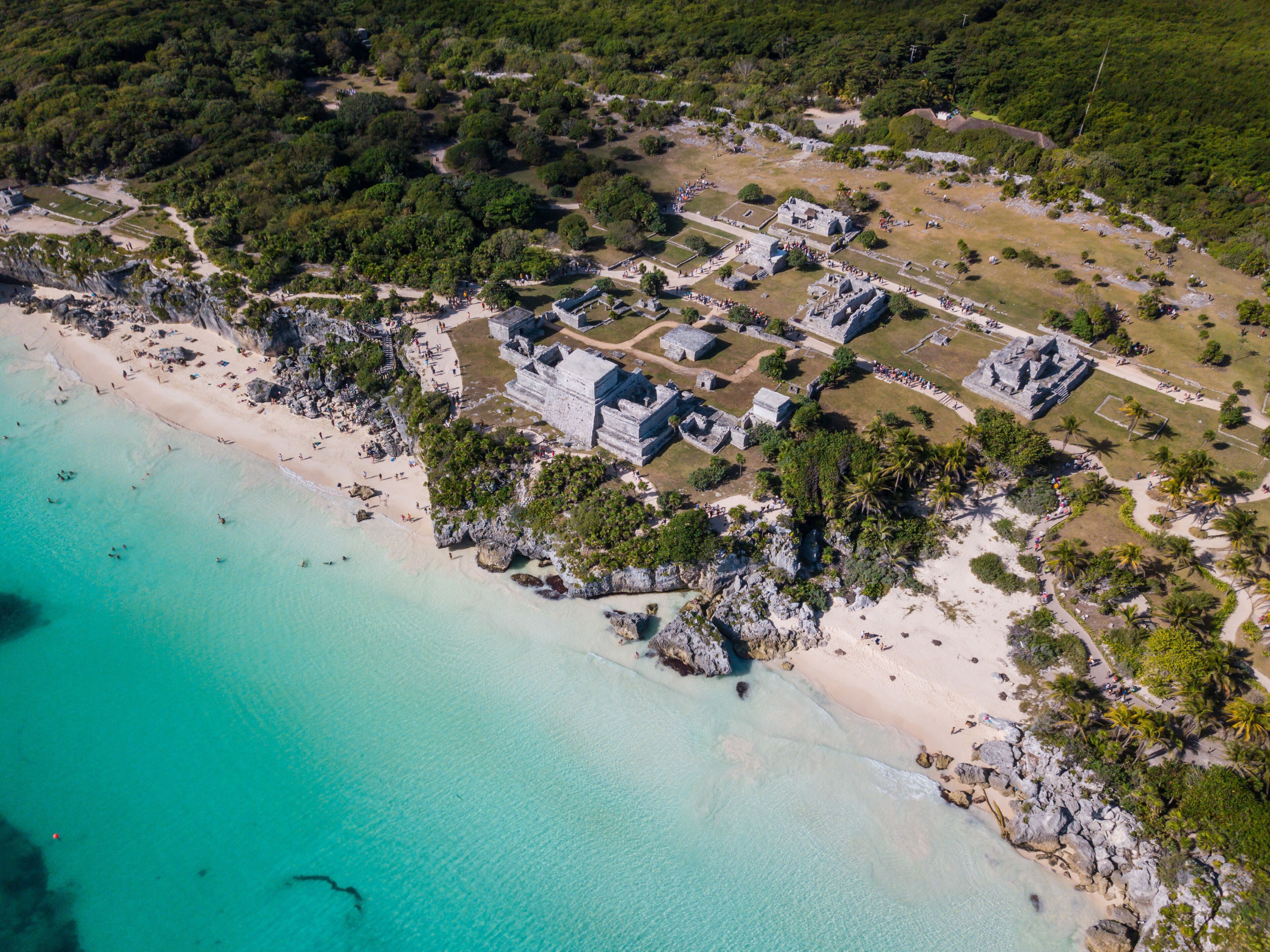 Ruins of Tulum, Mexico overlooking the Caribbean Sea in the Riviera Maya Aerial View. Tulum beach Quintana Roo Mexico - drone shot. White sand beach and ruins of Tulum.