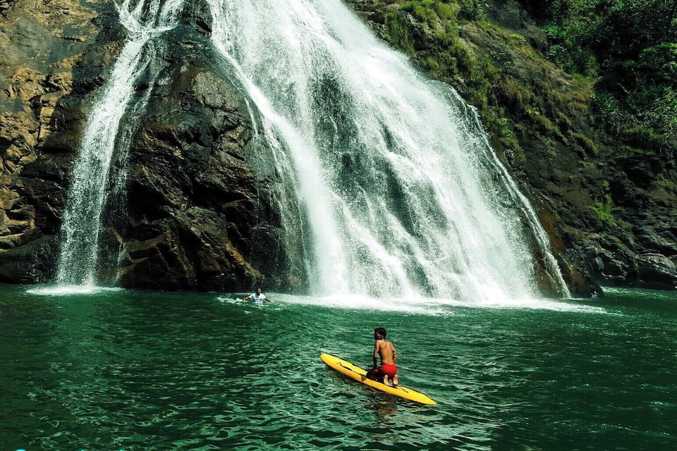 A waterfall cascading down a rocky cliff into a body of water.
