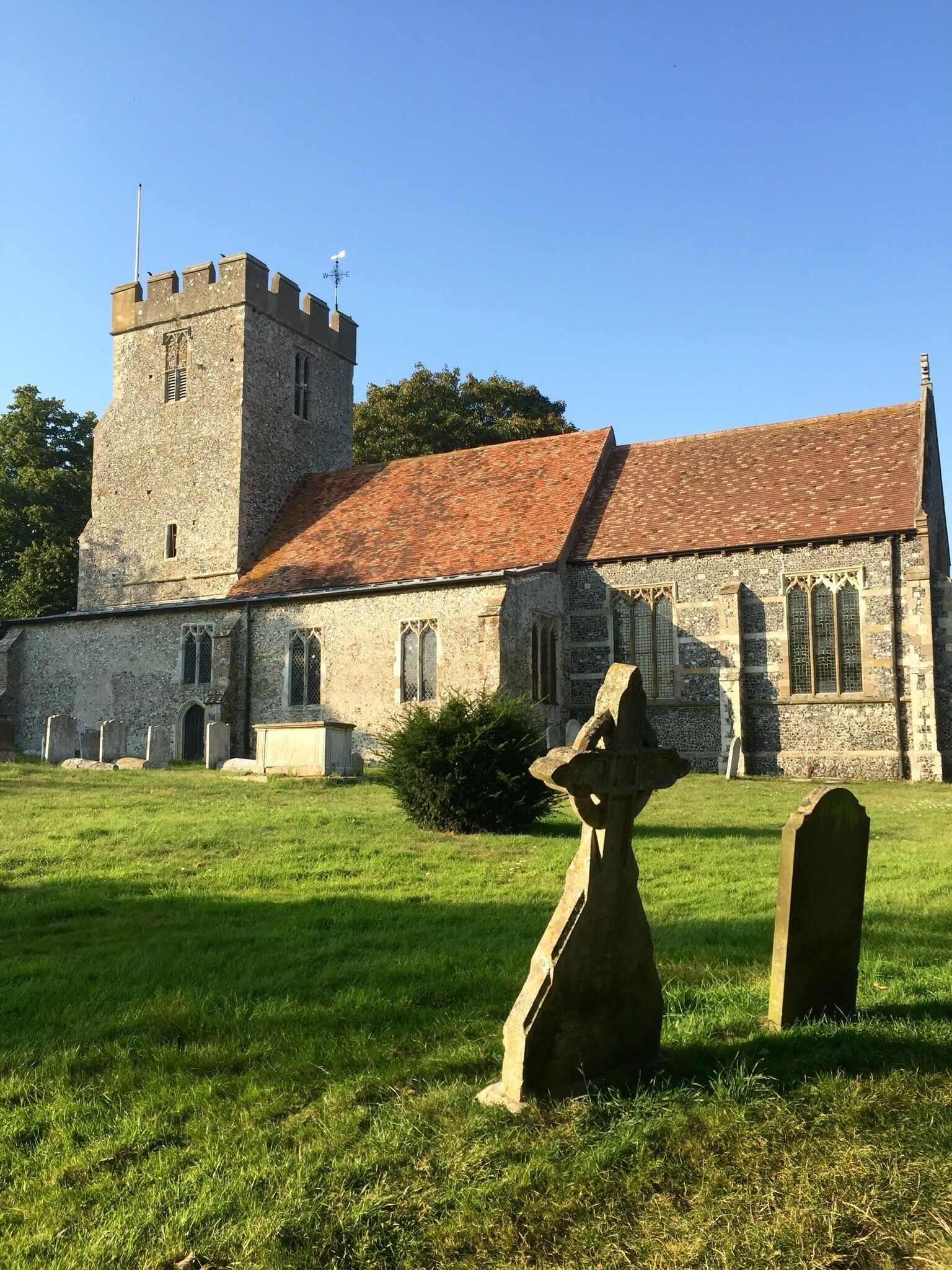 A historic church with a tower and a graveyard.