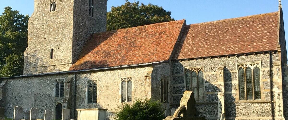 A historic church with a tower and a graveyard.