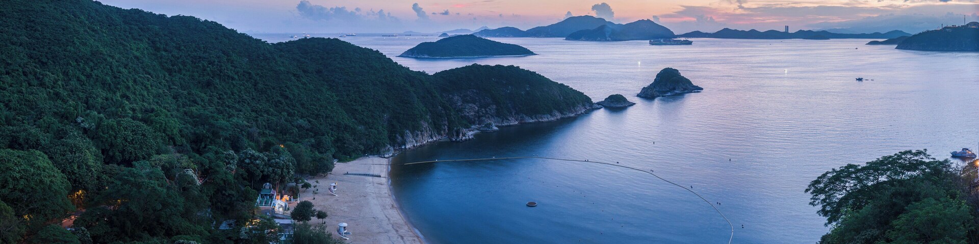 South Bay Beach on Hong Kong Island, Hong Kong. Viewed looking south-west. In the distance are Round Island (small island near the bay) and Lamma Island in the background is Lamma Power Station.